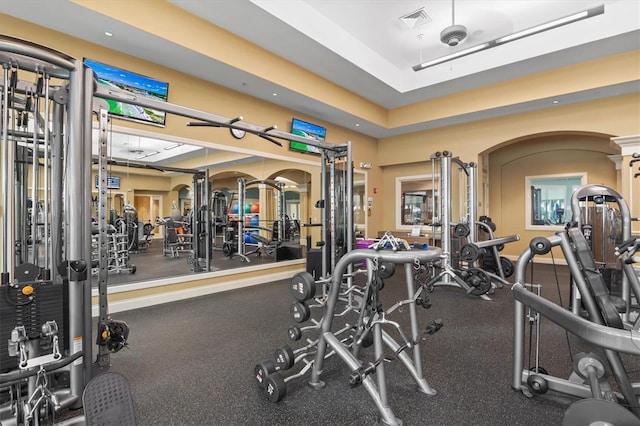 exercise room with a tray ceiling