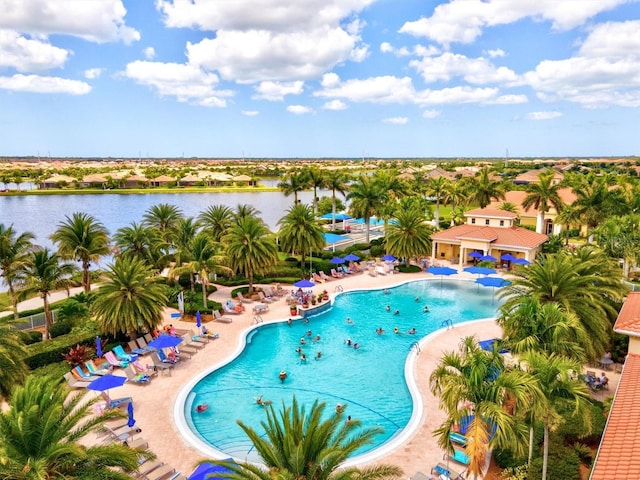 view of swimming pool with a water view and a patio