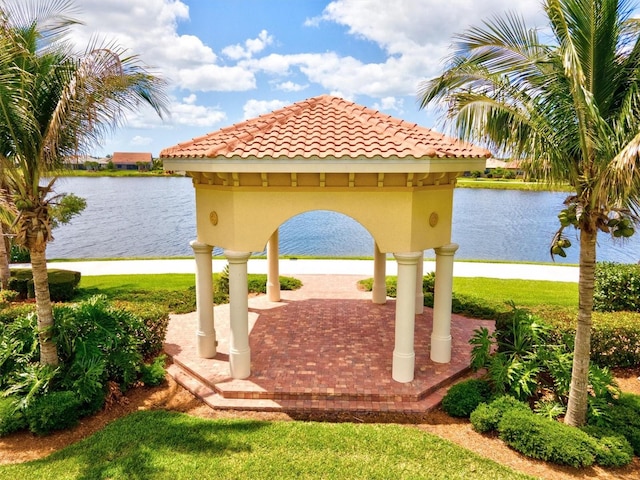 view of community featuring a gazebo, a water view, and a patio area