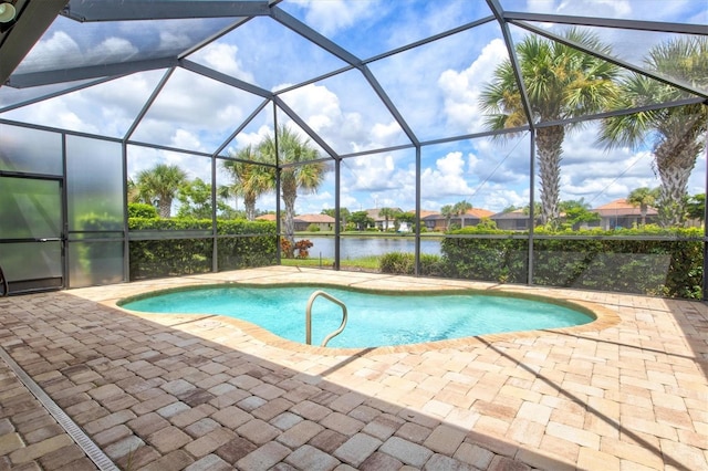 view of swimming pool with a patio, a water view, and glass enclosure