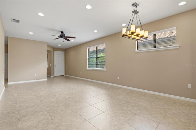 unfurnished room featuring ceiling fan with notable chandelier and light tile patterned floors