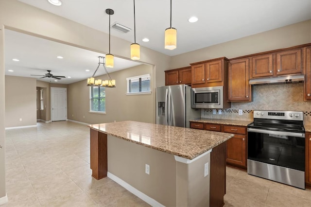 kitchen featuring hanging light fixtures, light stone counters, decorative backsplash, ceiling fan with notable chandelier, and appliances with stainless steel finishes