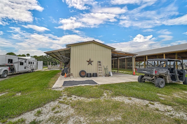 view of outbuilding featuring a yard and a carport