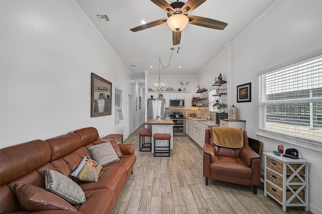 living room with ceiling fan, light hardwood / wood-style floors, crown molding, and sink