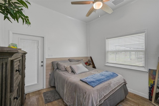 bedroom featuring ornamental molding, ceiling fan, and dark hardwood / wood-style floors