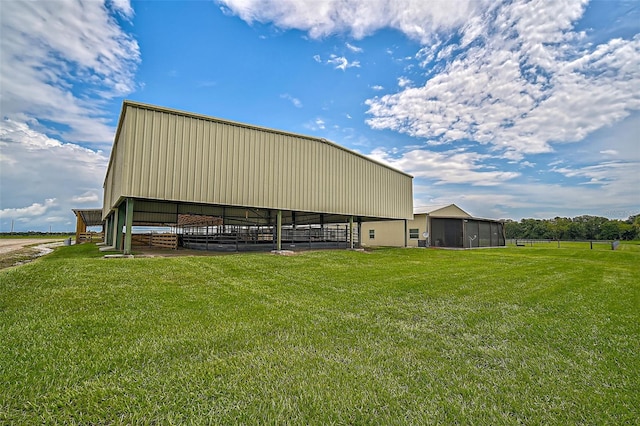 view of outbuilding featuring a lawn and a rural view