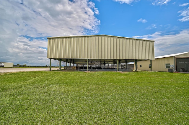 view of outbuilding featuring a lawn