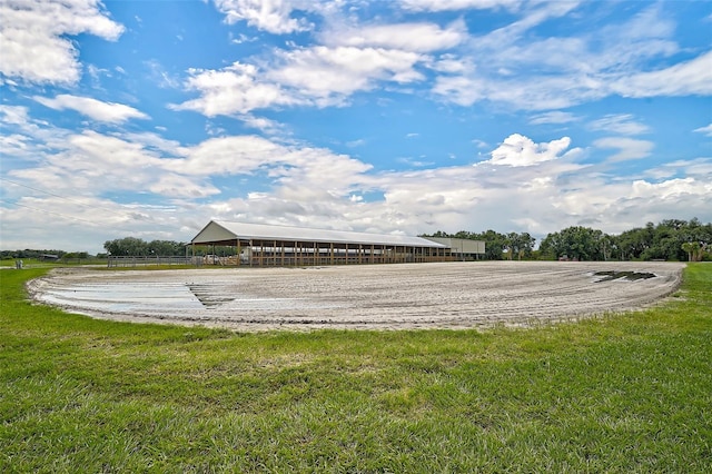 exterior space featuring a lawn and a rural view