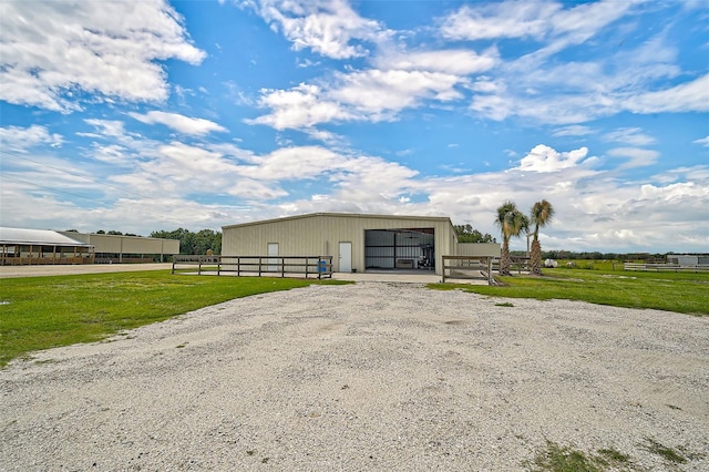 view of outdoor structure featuring a yard and a garage