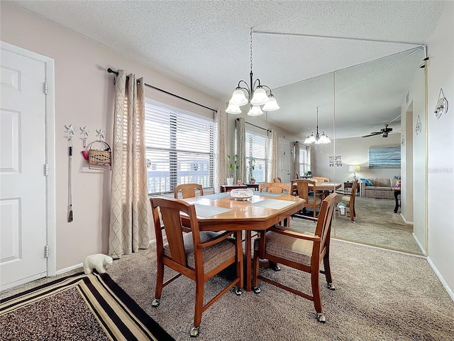 dining space featuring ceiling fan with notable chandelier, a textured ceiling, and carpet flooring