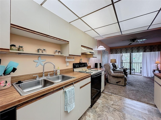 kitchen featuring white cabinets, decorative light fixtures, sink, white range with electric stovetop, and a drop ceiling