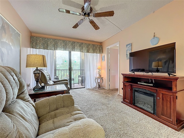 carpeted living room featuring a textured ceiling and ceiling fan