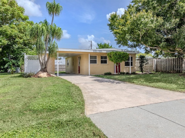 ranch-style home with a carport and a front yard