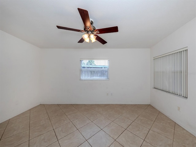 unfurnished room with ceiling fan and light tile patterned floors