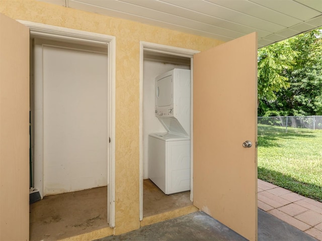 exterior space featuring stacked washer and clothes dryer