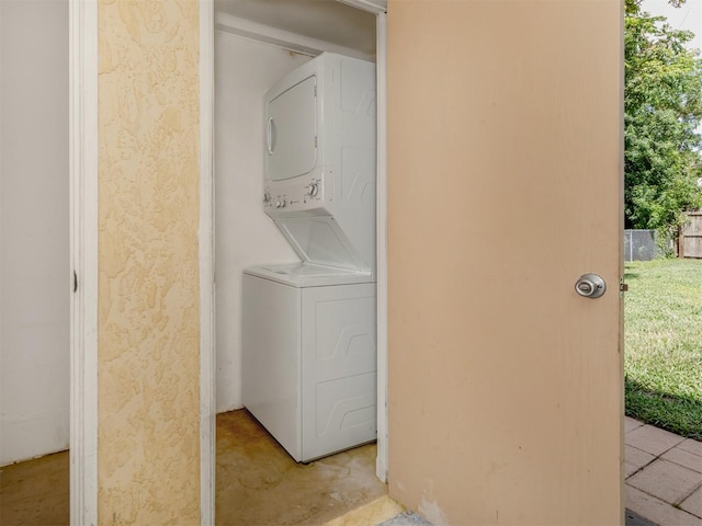 washroom with stacked washer and dryer