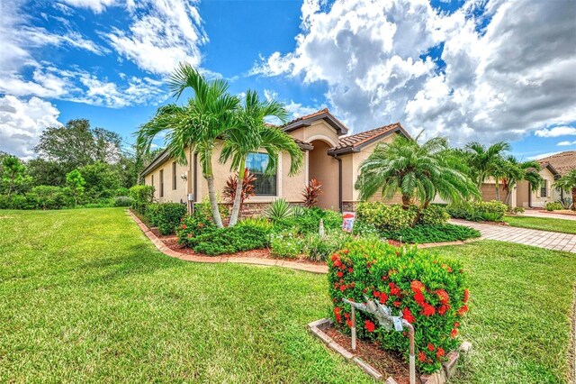 mediterranean / spanish-style house with a front yard