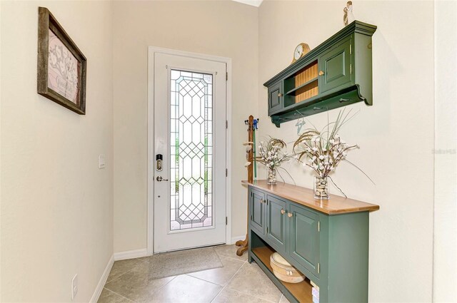 foyer entrance with light tile patterned flooring