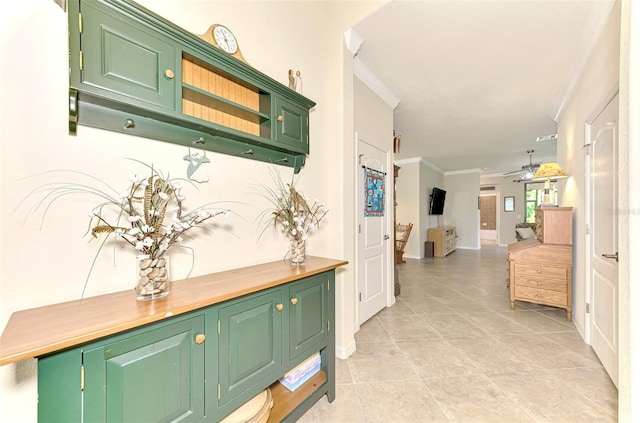 corridor with crown molding and light tile patterned floors