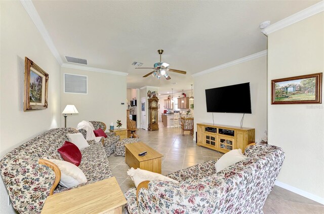 tiled living room featuring ceiling fan and crown molding