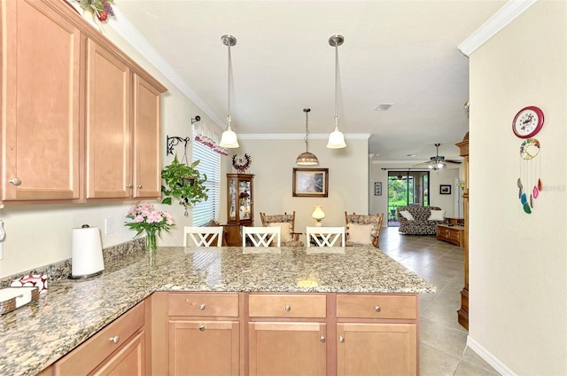 kitchen with light tile patterned floors, crown molding, decorative light fixtures, light stone countertops, and ceiling fan