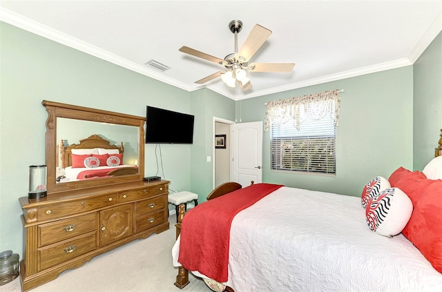 carpeted bedroom featuring crown molding and ceiling fan