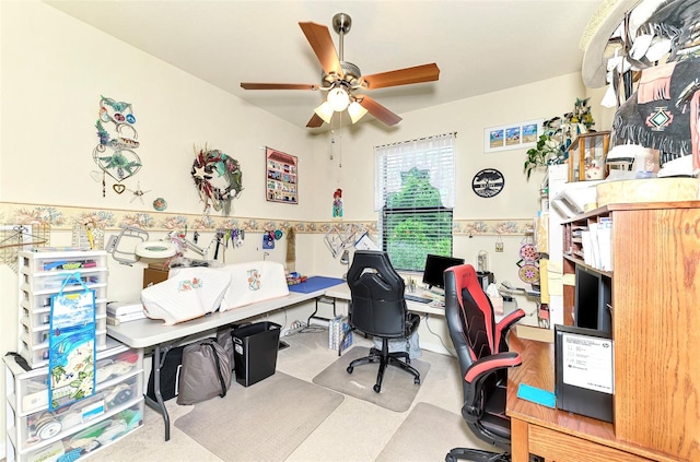 carpeted office space featuring ceiling fan