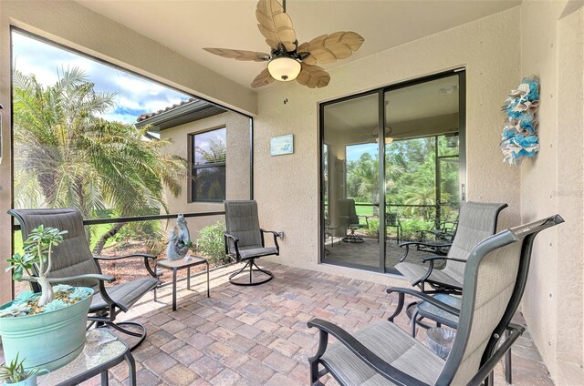 sunroom featuring ceiling fan