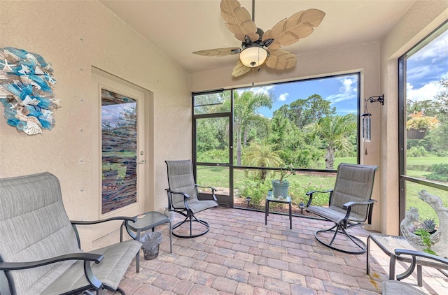 sunroom featuring ceiling fan