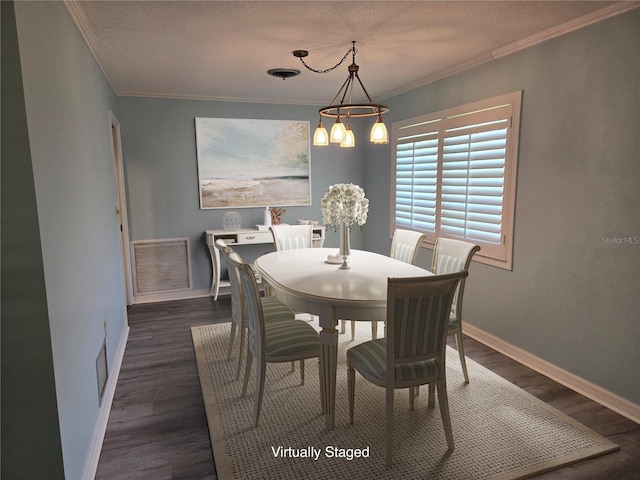 dining space featuring dark wood-type flooring, an inviting chandelier, and crown molding