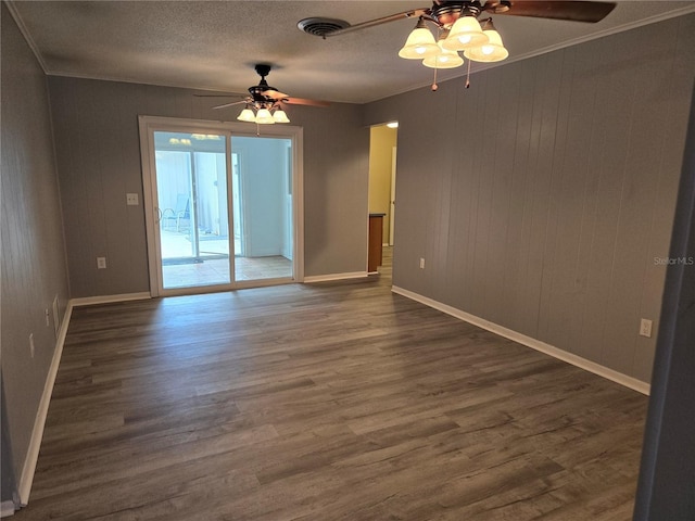 unfurnished room featuring baseboards, visible vents, ornamental molding, dark wood-type flooring, and a textured ceiling