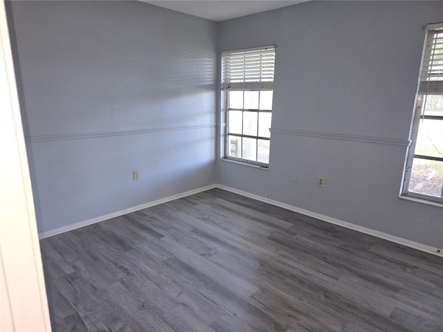 unfurnished room featuring dark hardwood / wood-style flooring