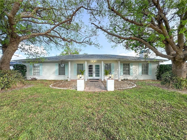 single story home featuring stucco siding, french doors, and a front lawn