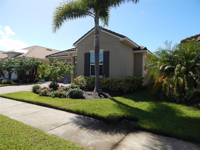 view of side of home featuring a lawn