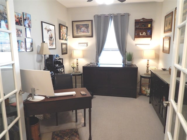 office space featuring ceiling fan and light carpet