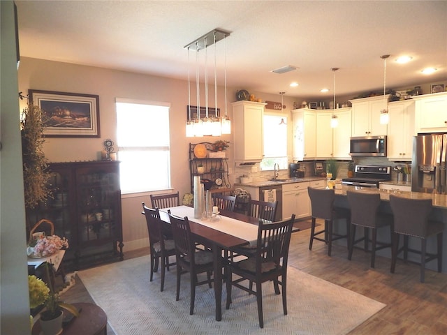 dining space featuring dark hardwood / wood-style flooring and sink