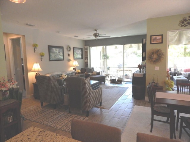 living room featuring ceiling fan and wood-type flooring