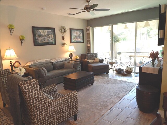 living room with wood-type flooring and ceiling fan