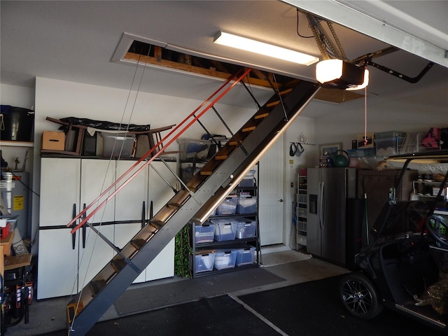 garage with a garage door opener and electric water heater