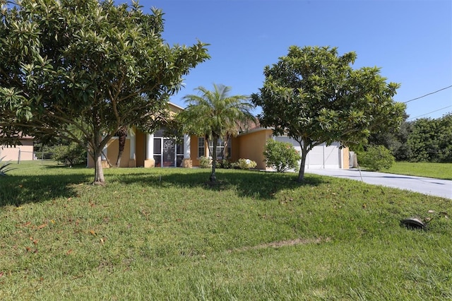 view of property hidden behind natural elements with a front yard