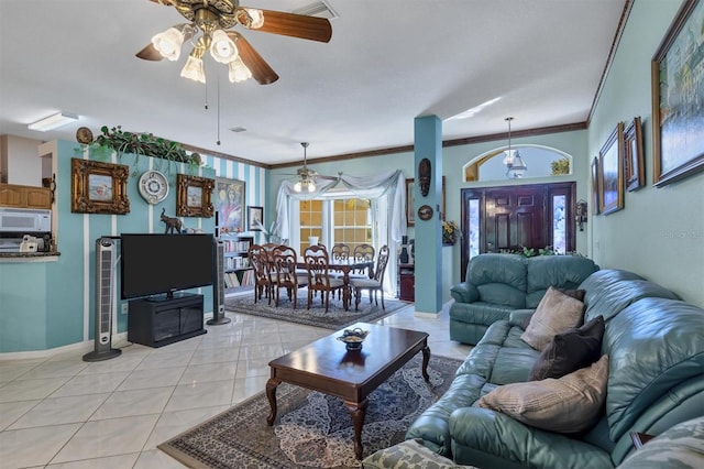 living room featuring crown molding, ceiling fan, and light tile patterned floors