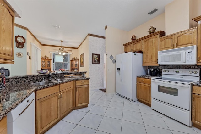 kitchen with dark stone counters, ornamental molding, white appliances, sink, and ceiling fan