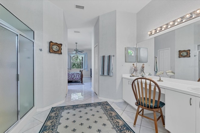 bathroom with tile patterned floors, ceiling fan, an enclosed shower, and vanity