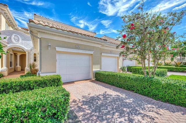 mediterranean / spanish-style home featuring a garage