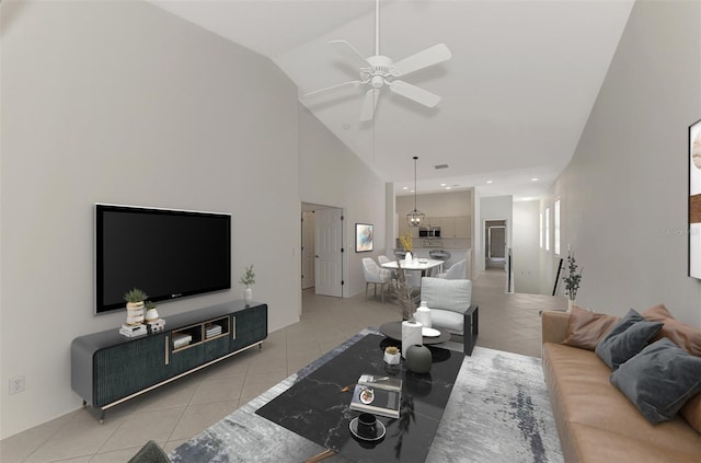 living room with ceiling fan, light tile patterned floors, and high vaulted ceiling