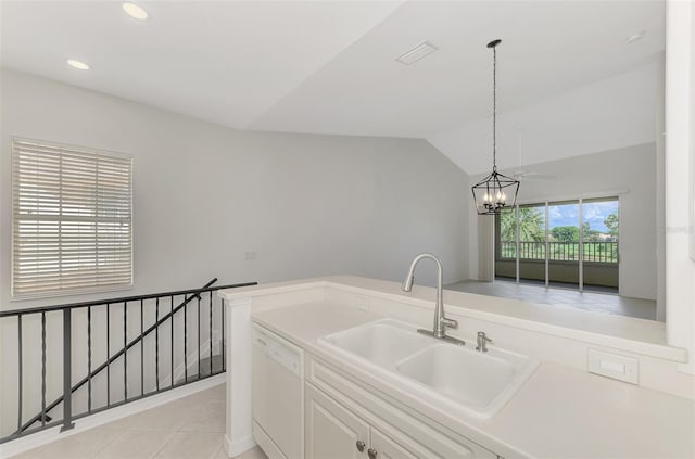 kitchen with white dishwasher, pendant lighting, sink, a chandelier, and lofted ceiling