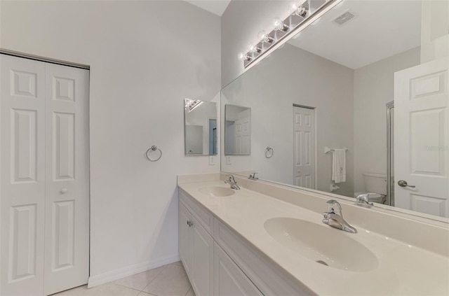 bathroom featuring tile patterned flooring, vanity, and toilet