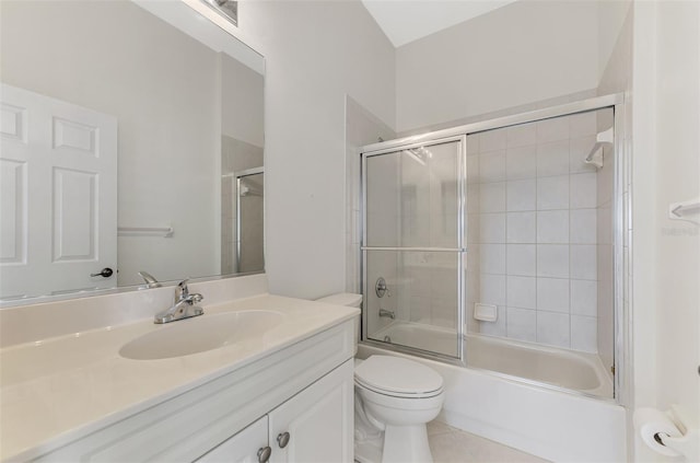 full bathroom featuring shower / bath combination with glass door, vanity, toilet, and tile patterned flooring