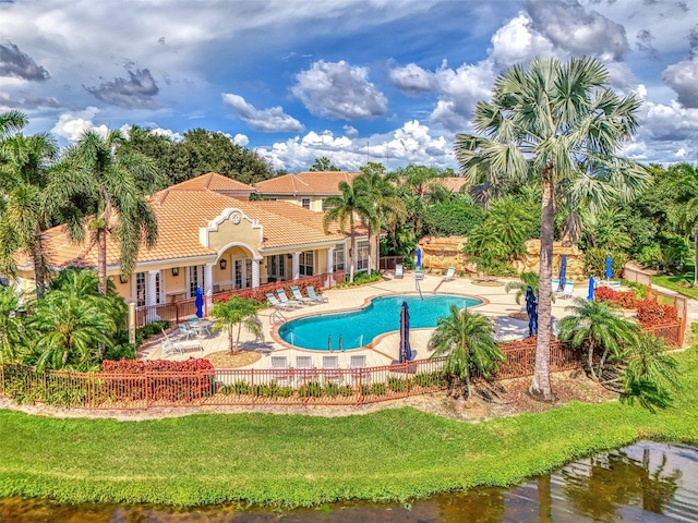 view of pool with a lawn and a patio