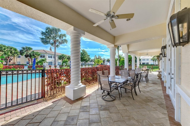 view of patio featuring a fenced in pool and ceiling fan